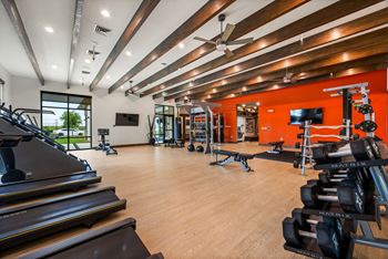 A gym with treadmills, weights, and exercise equipment. at The Haywood Apartments, Austin, TX